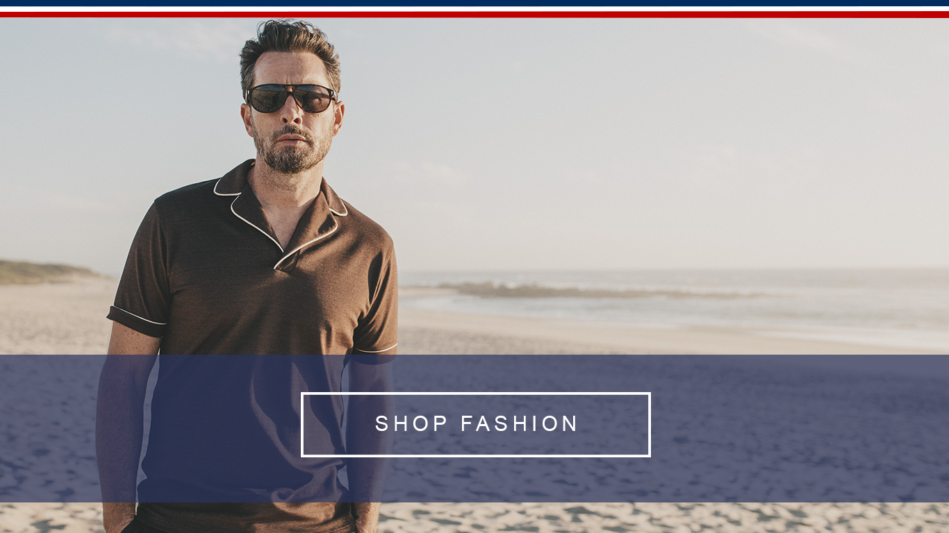 Stylish man in casual look wearing a brown polo shirt and cool sunglasses in retro design on the beach