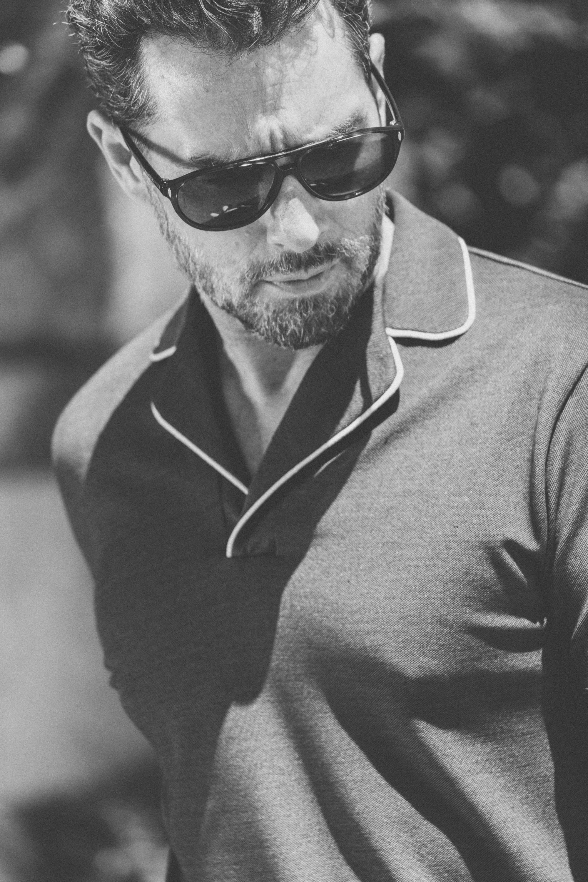 Man elegant and cool wearing sunglasses and polo shirt in retro design